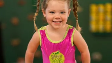 A Three Pea gymnast in a Sweet Peas leotard during preschool gymnastics at Cal Elite