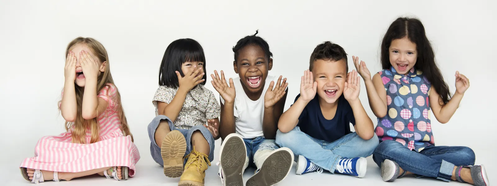 A diverse group of children smiling together during a Cal Elite day camp