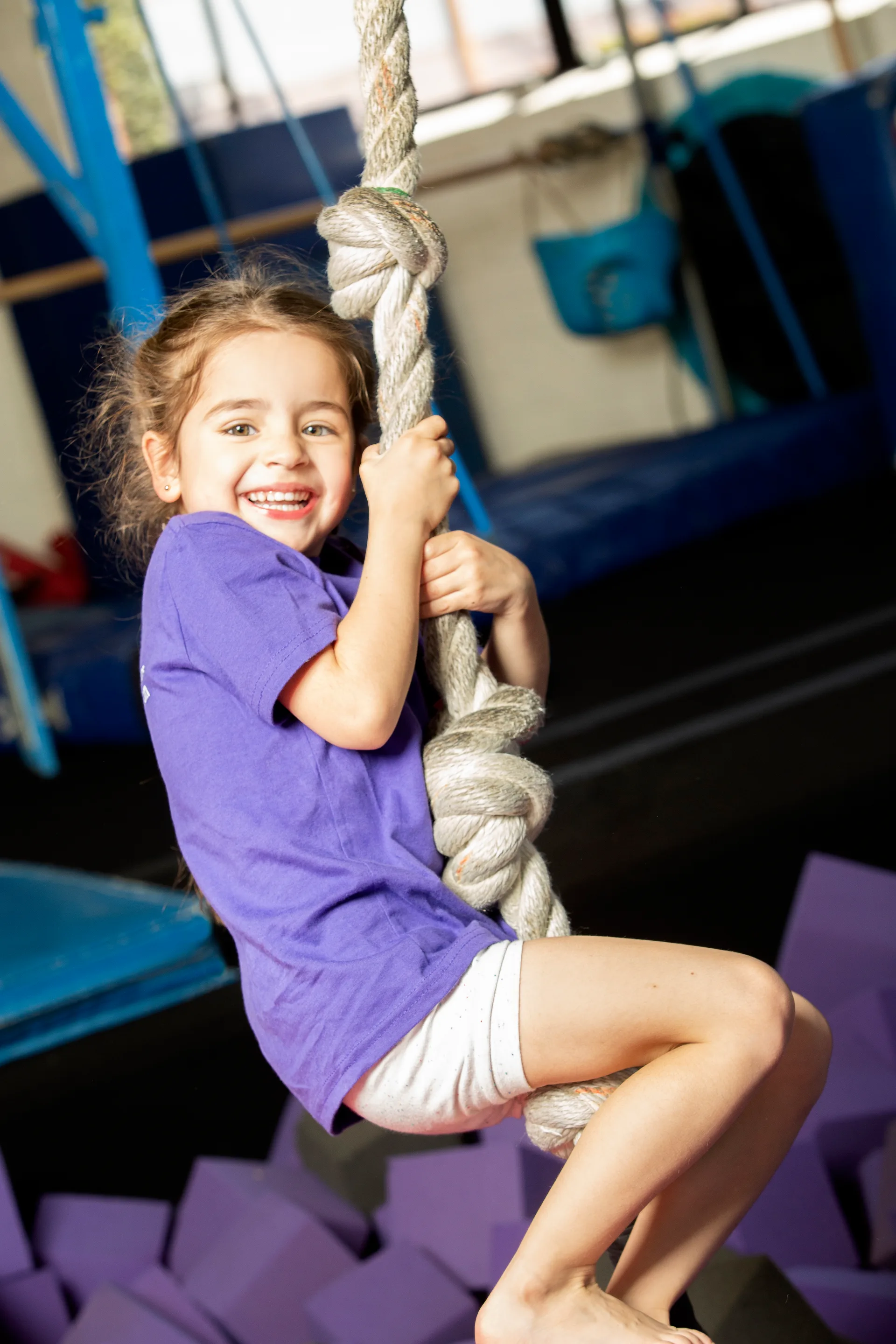 A young Cal Elite gymnast posing in the gym