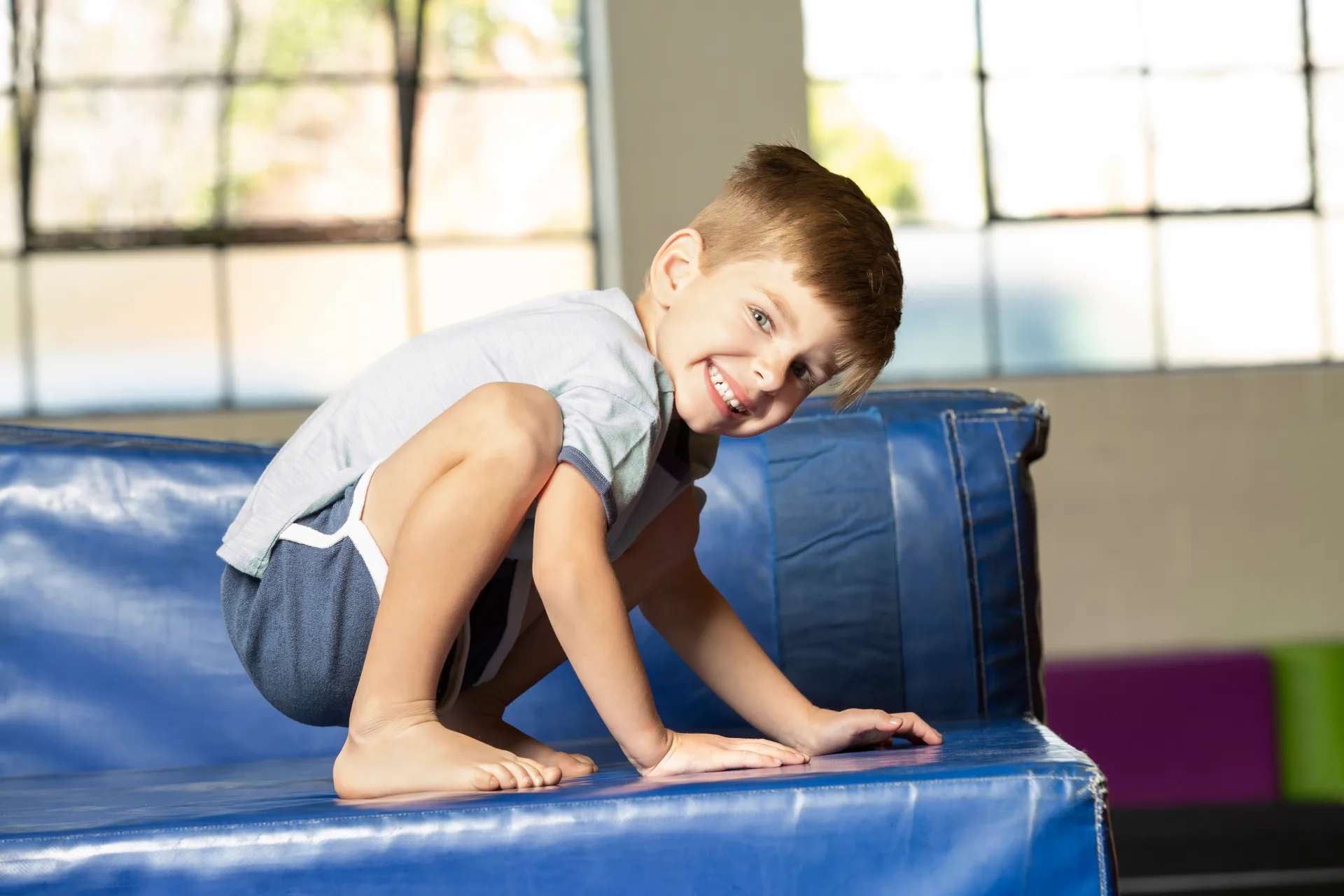A preschool gymnast practicing with a coach at Cal Elite