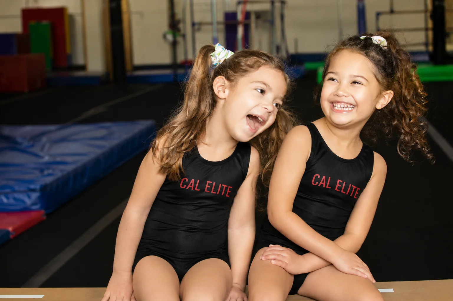 Cal Elite gymnasts practicing together in the gym