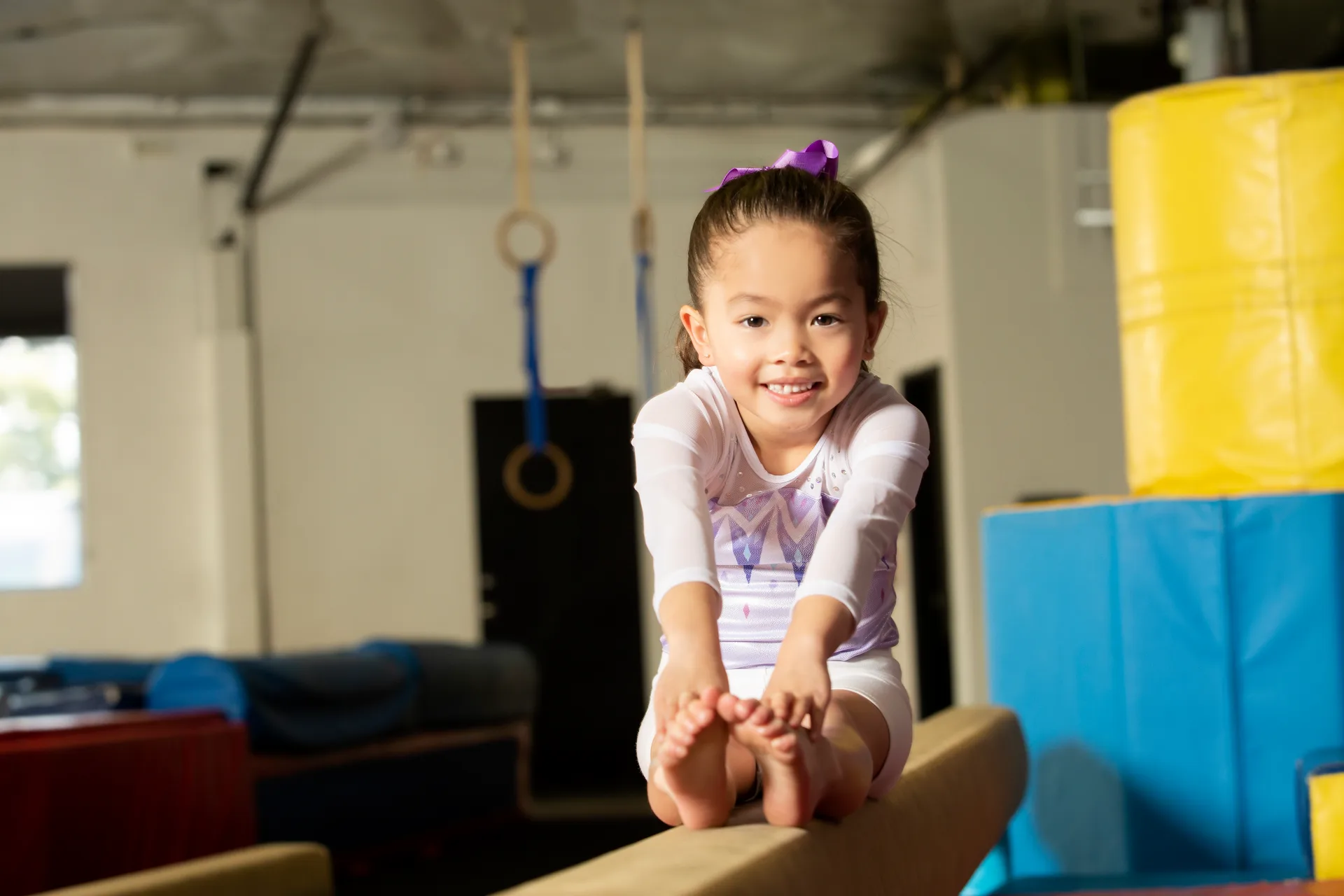 A Level 3 gymnast practicing with a coach at Cal Elite