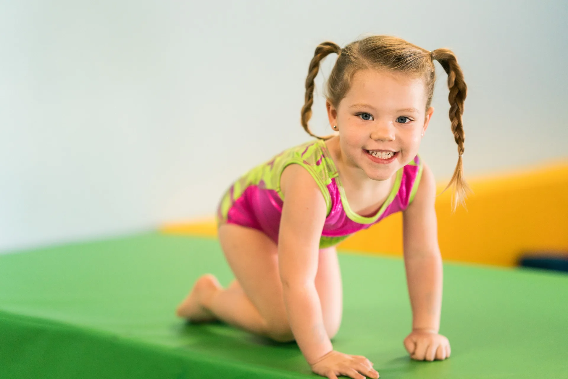 A young gymnast practicing on a block during a Cal Elite class
