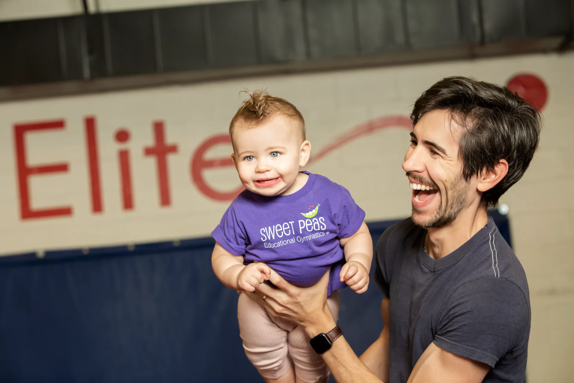 A young gymnast practicing with a coach at Cal Elite